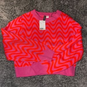 Pink and orange cropped knit sweater